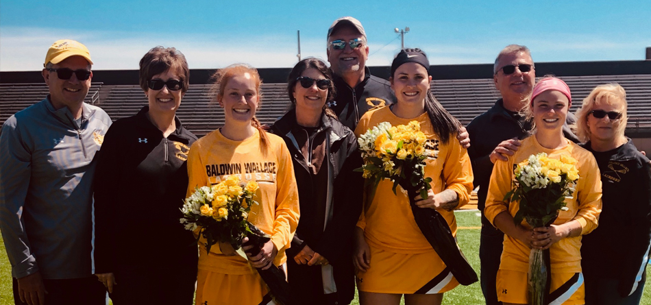 Seniors Mackenzie Moran, Hannah Albrechta and Megan Patrick with their parents on Seniors' Day (Photo courtesy of Lexi Ripperger)