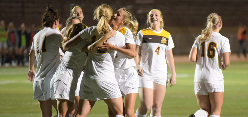 The women's soccer team celebrates a goal (Photo by William Lekan)